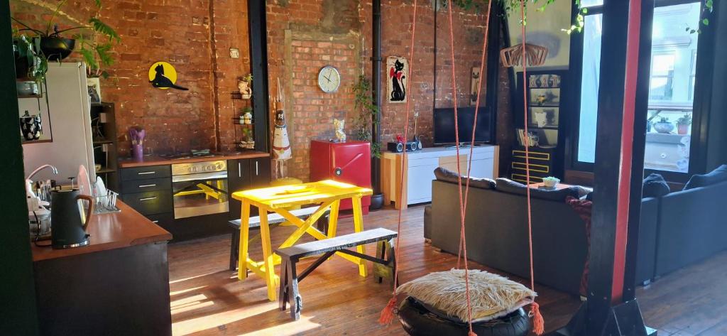 a room with a kitchen with a table and a couch at Cat-themed East City Loft Apartment in Cape Town
