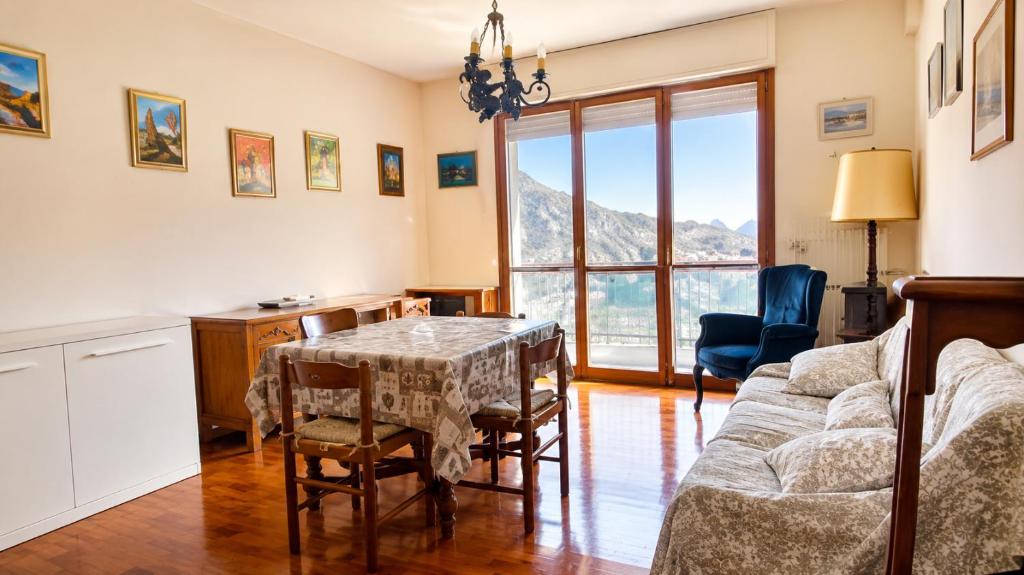 a living room with a table and a table and chairs at Casa Eliana - Camporosso in Camporosso