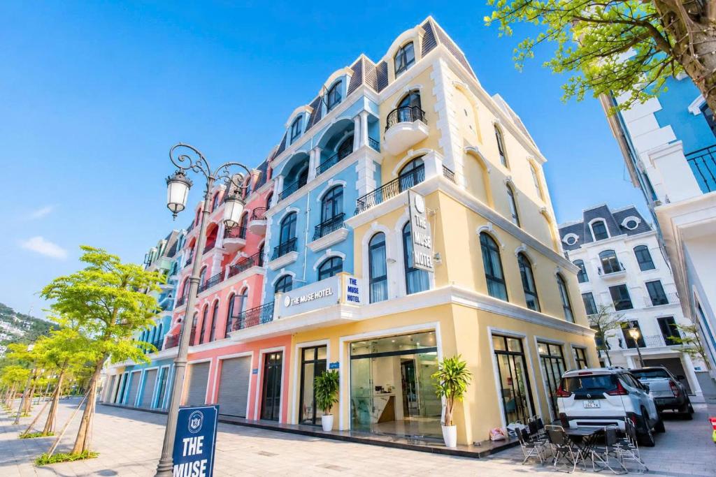 a yellow and white building on a city street at The Muse Hotel 3 in Ðố Sơn