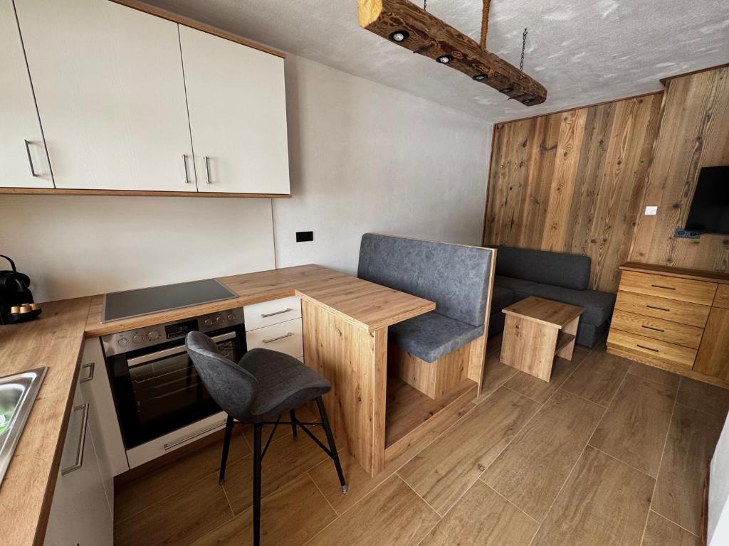 a kitchen with a table and a chair in it at Ferienwohnung Almzeit in Gressenberg