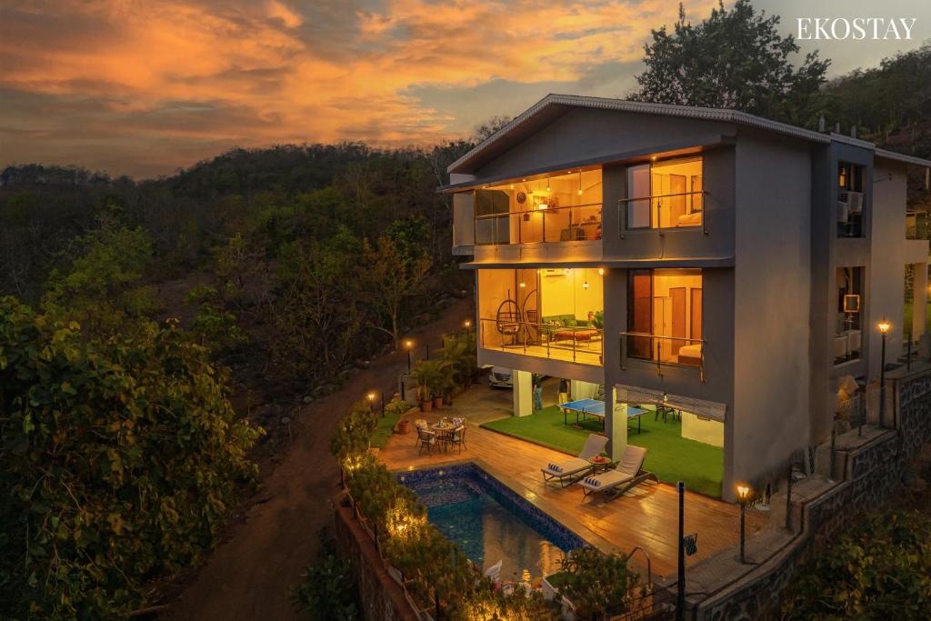 an aerial view of a house with a pool at EKOSTAY - Amani Villa in Khopoli
