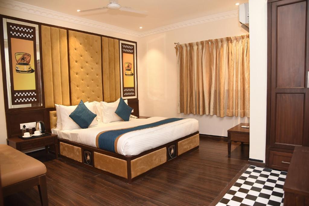 a hotel room with a bed in a room at Belair Suites in Pune