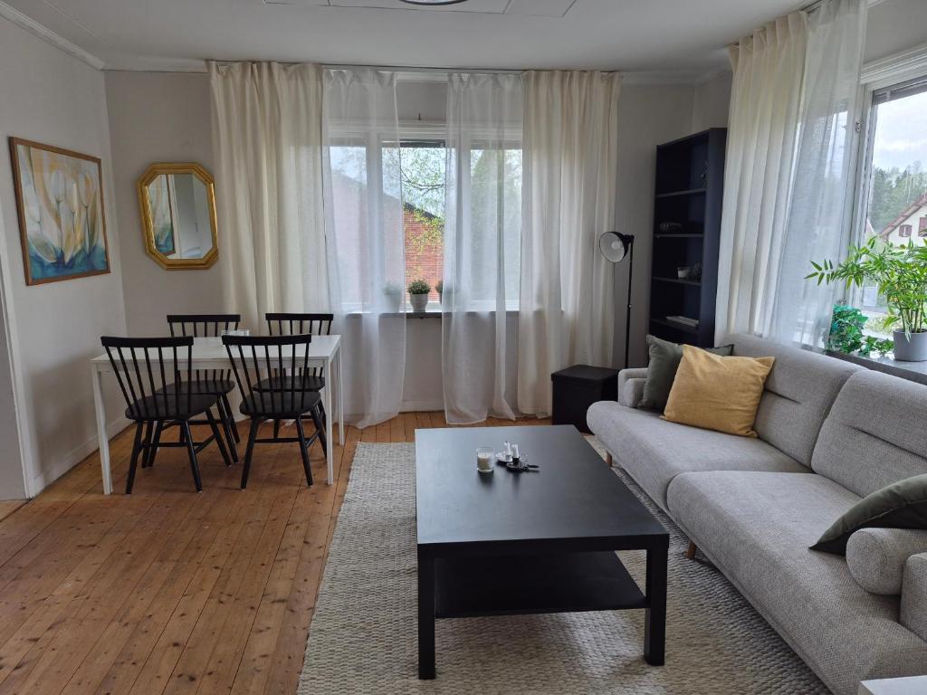 a living room with a couch and a table at Lägenhet i Sandhem in Sandhem