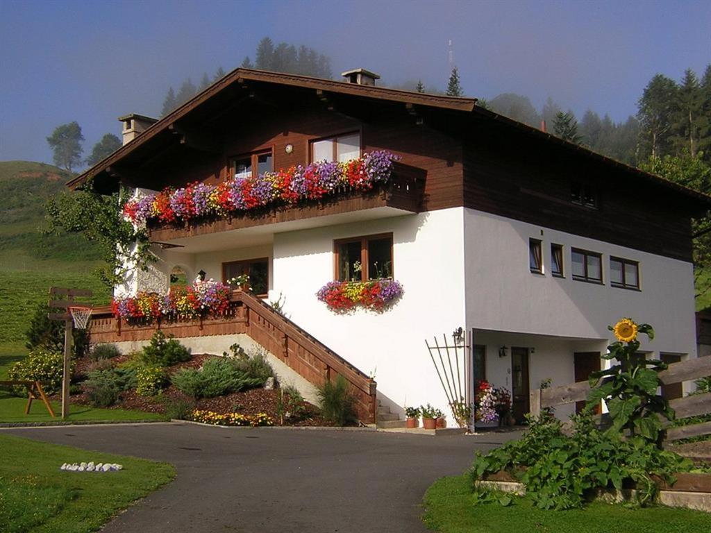 a house with flower boxes on the side of it at Ferienwohnungen Dagn in Kössen