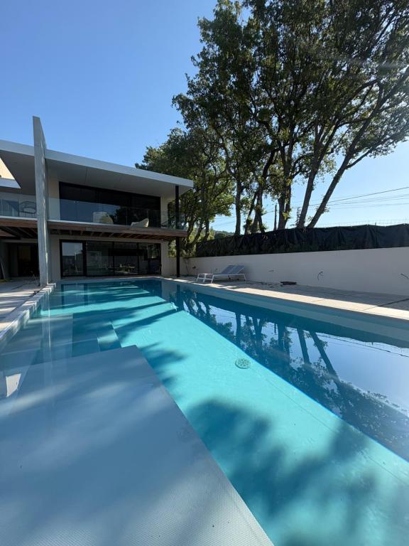 a swimming pool in front of a house at Villa Loka-Ecrin contemporain Adult only in Sauzet