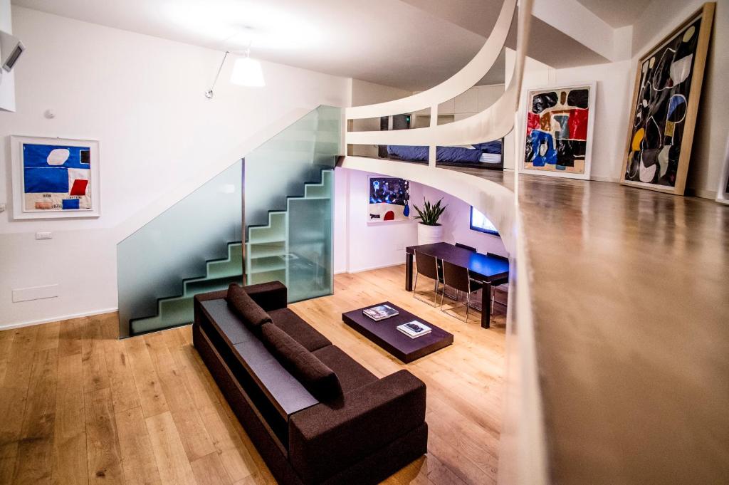 a living room with a couch and a staircase at Gallery House in Perugia