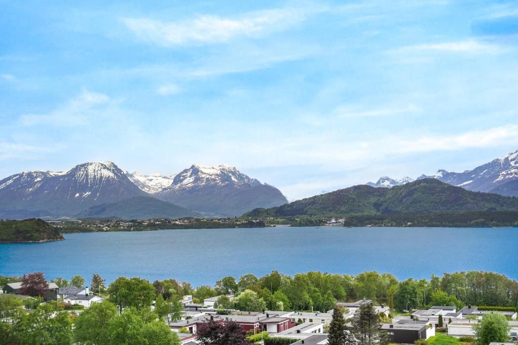 a view of a lake with snow capped mountains at A11 Apartments in Ålesund