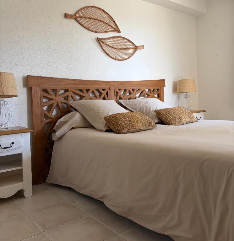 a bedroom with a large bed with two pillows at Chambre 2 dans un petit paradis in La Londe-les-Maures