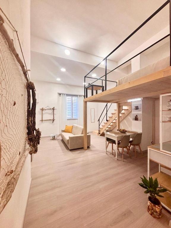 a living room with a loft conversion with a staircase at Piombino Monolocale Poseidonia in Piombino