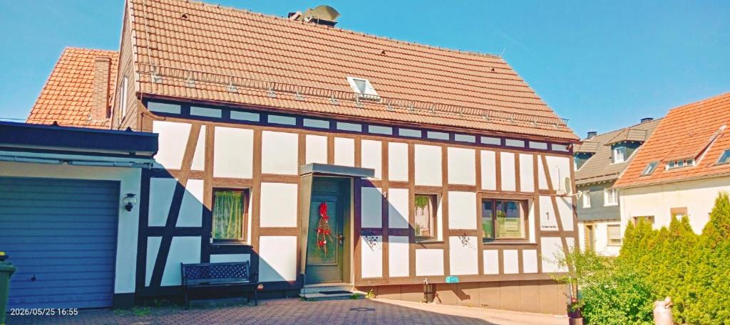 a house with a red roof and a blue garage at Ferienhaus Medebach in Medebach