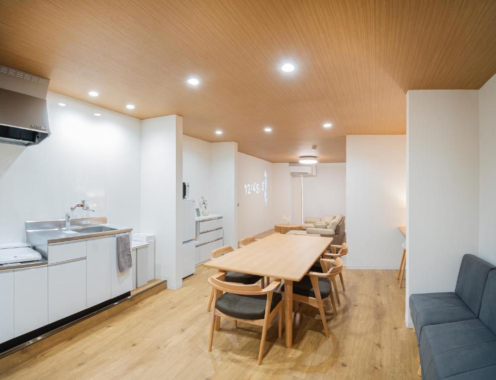 a kitchen and dining room with a table and chairs at HOTEL Itsuki in Onomichi