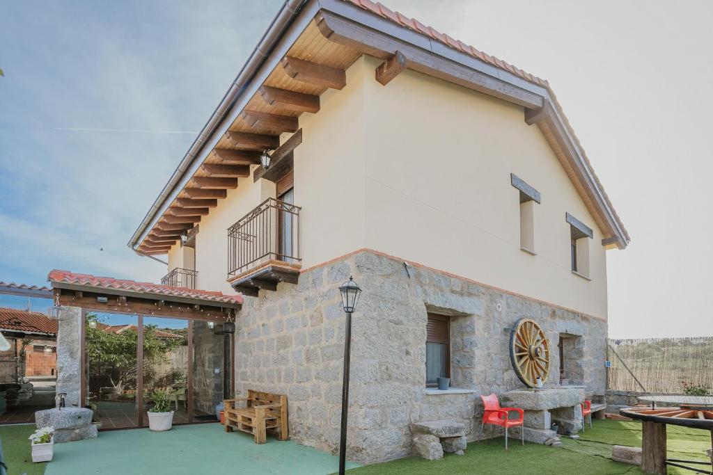 a large white building with a patio and a table at El Trillo in Marlín