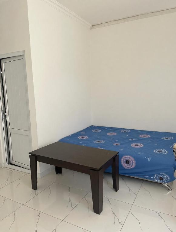 a small bed with a table in a room at Арев in Yerevan