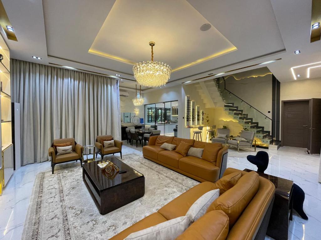 a large living room with couches and a dining room at Luxury 5 BR Villa with Pool,Cinema Lekki in Lekki