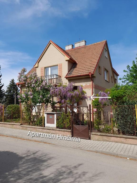 a house with a fence in front of a street at Hrnčírna in Kněževes
