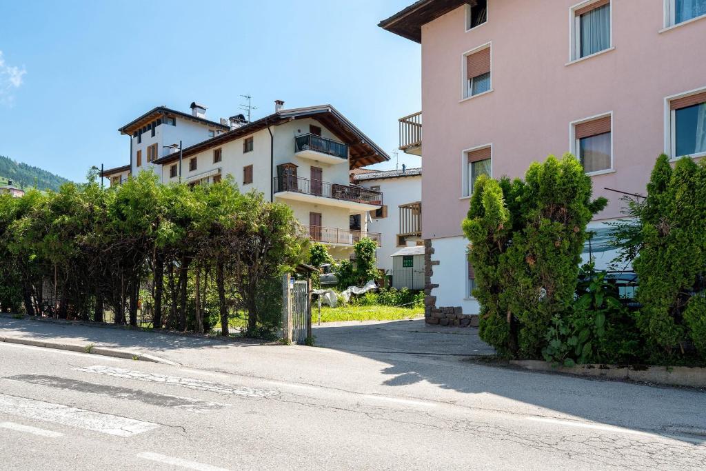 an empty street in front of a building at Casa Rosa in Levico Terme