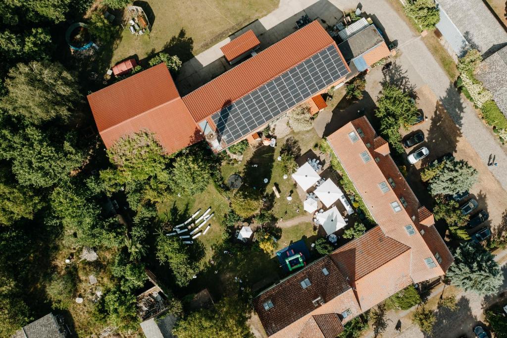 an overhead view of a house with a solar roof at Fliederhof Stücken Apartments bei Potsdam in Michendorf