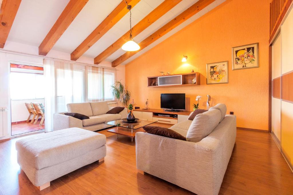 a living room with two couches and a tv at Apartment Štinjan in Pula