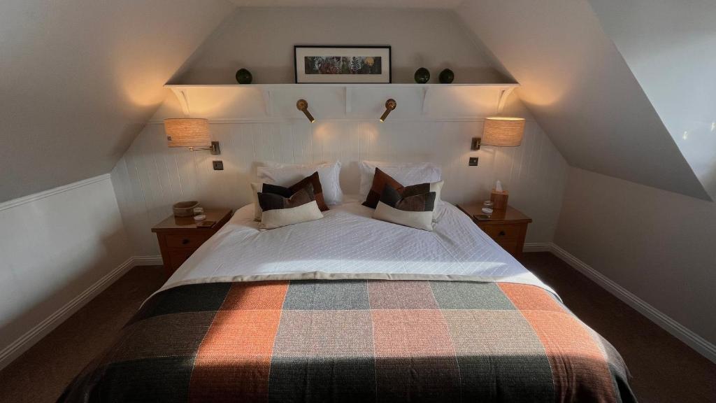 a bedroom with a large bed with two night stands at Ceol na Mara Guest House in Tarbert