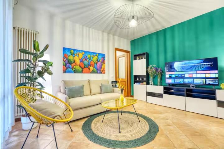 a living room with a couch and a tv at Private Parking & Garden -Luxury B&B-700mt Tower in Pisa