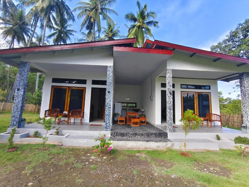 a small house with a patio at FaqinHomestay in Pulau Sarang