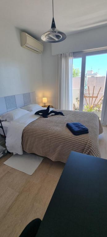 a bedroom with a large bed and a large window at Chambres d'hôtes - Bed & Breakfast - chez Denis-Jo in Toulon