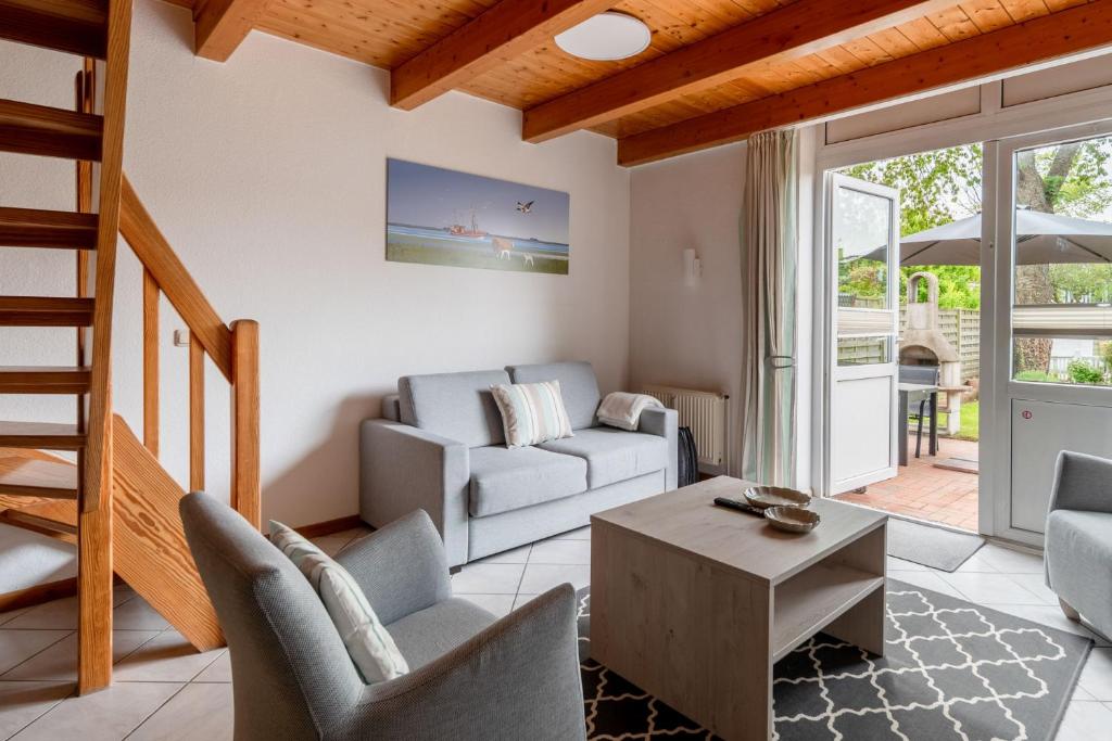 a living room with a couch and a table at Nordsee-Apartments Hinrichsen in Husum