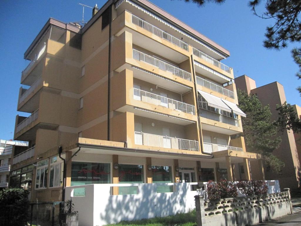 a tall building with balconies on the side of it at Appartamento Island Brioni in Grado-Pineta
