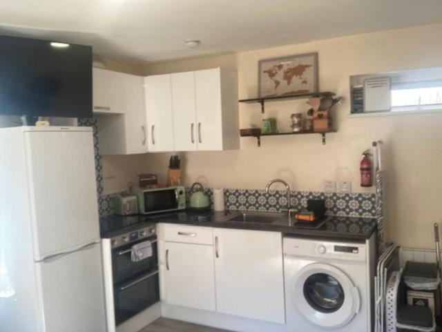 a kitchen with a white refrigerator and a dishwasher at MeadowView Apt B -2 mins walk Carrigaline town -sleeps 4 - 2 Adults and 2 Kids in Carrigaline