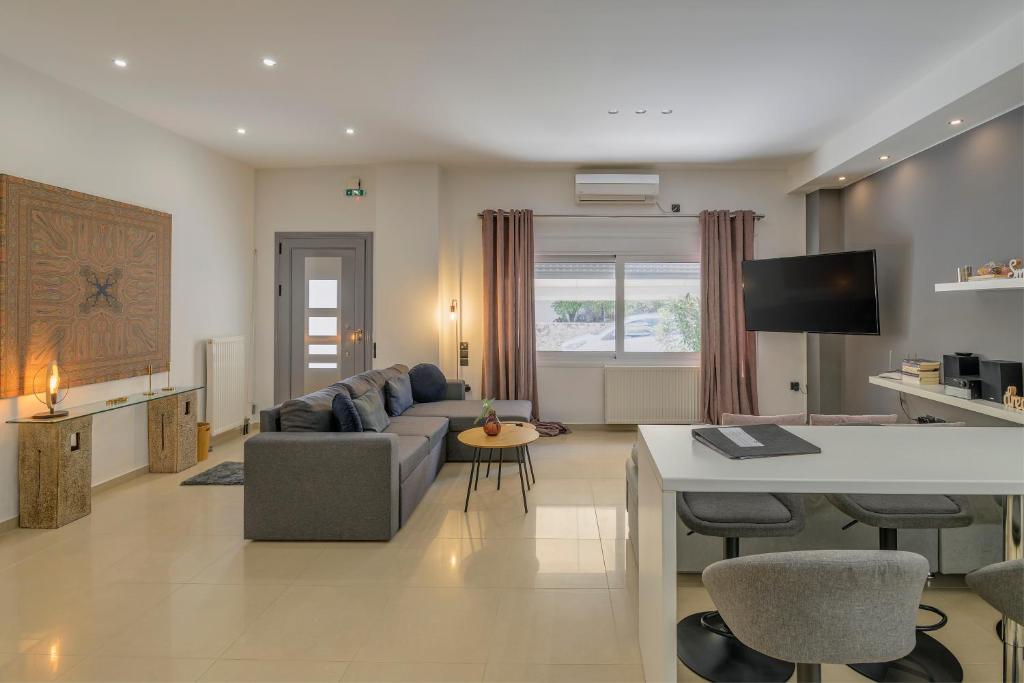 a living room with a couch and a table at Kalafatis Downtown Apartment in Itea