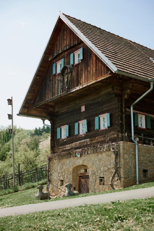 a large wooden building on the side of a road at Weingut Bleyweis in Kitzeck im Sausal
