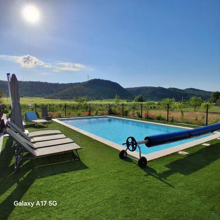 a pool with a bench and a large inflatable at La Case in Rosières
