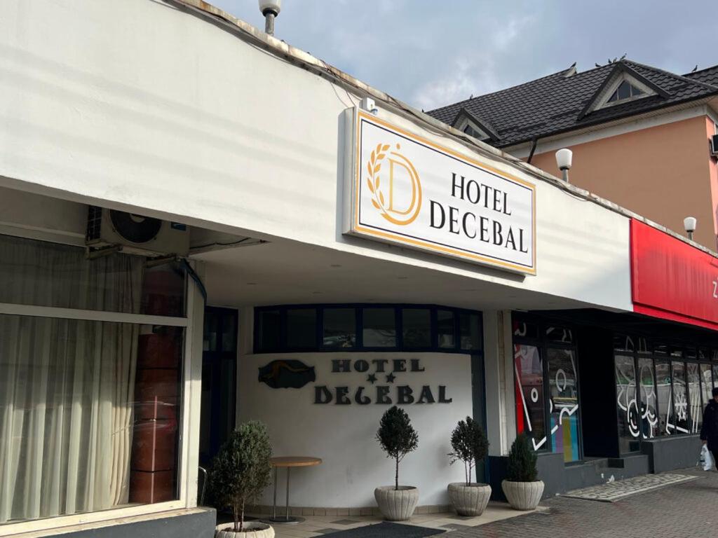 a hotel directional sign on the front of a building at Hotel Decebal Bistrita in Bistriţa