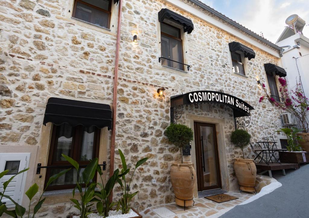 a building with a sign on the side of it at Cosmopolitan Suites in Parga