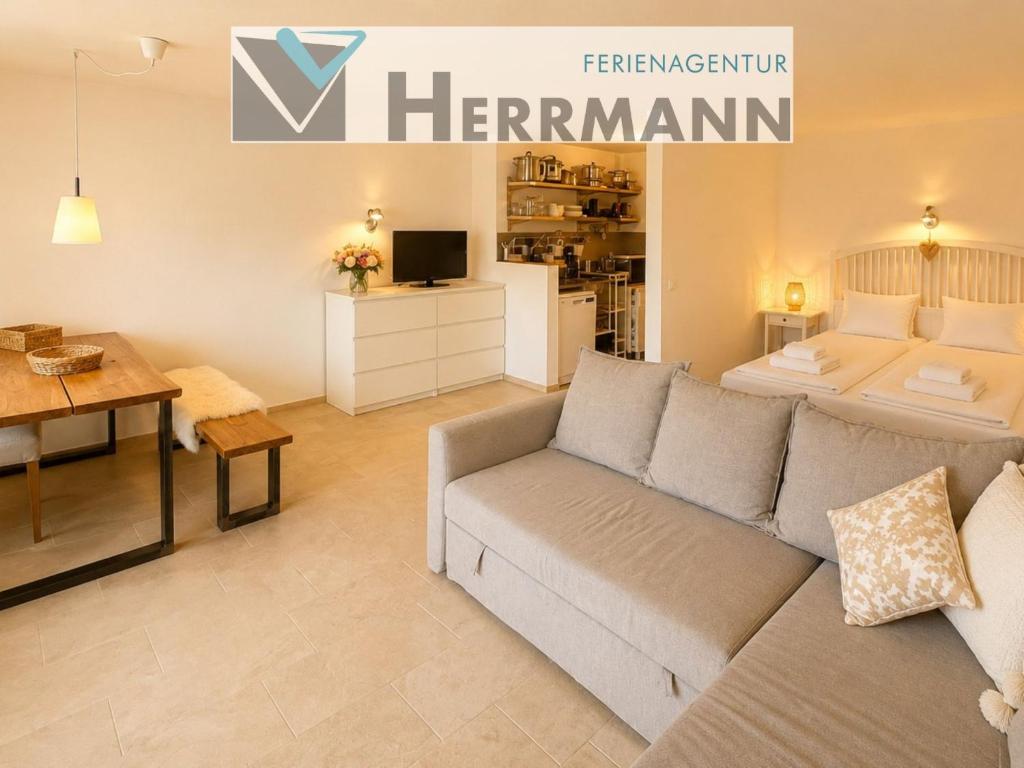 a living room with a couch and a kitchen at Ferienappartement Greta in Lechbruck
