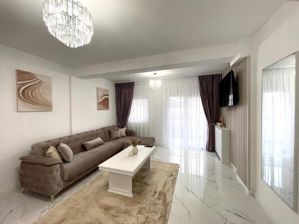 a living room with a couch and a table at Apartament Bucovina Bellevue in Gura Humorului