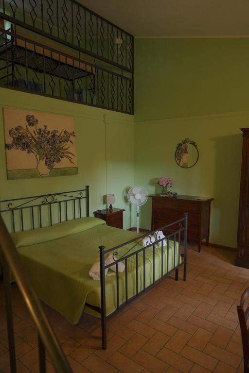 a bedroom with a bed in a room with green walls at La dimora degli Etruschi in Civitella Cesi