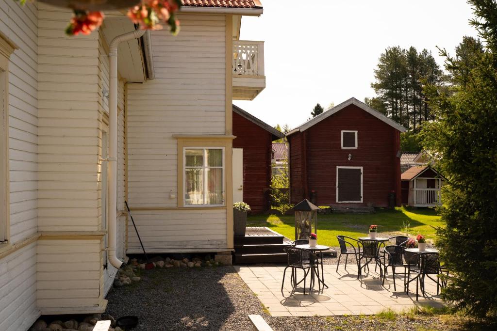 a patio with tables and chairs next to a house at B&B Villa Kauppila in Ii