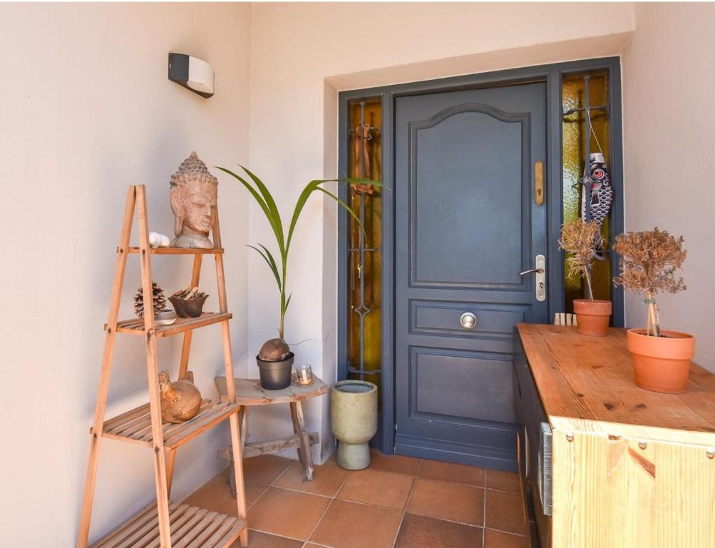 a blue door in a room with plants and vases at Begur "Casa es Pou" in Begur