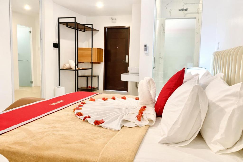 a bedroom with a bed with a rooster on the floor at Mayumi Lodge in Puerto Princesa City