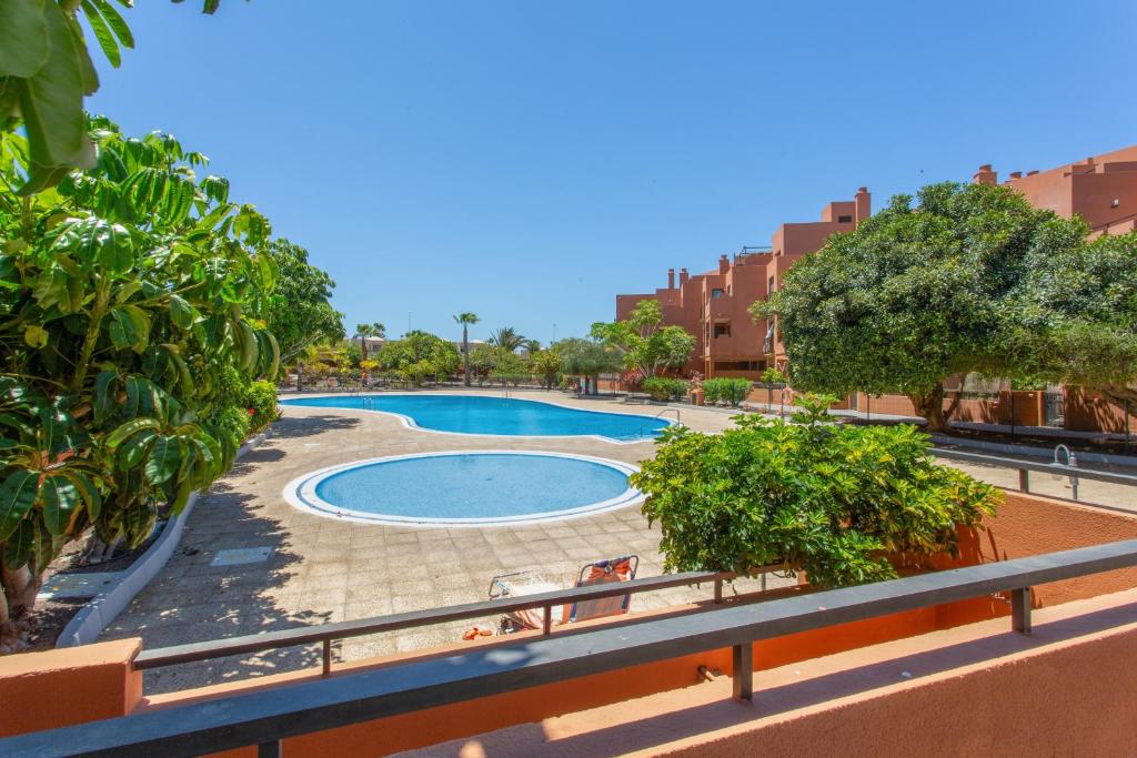a swimming pool in the middle of a city at Veras Home in La Tejita