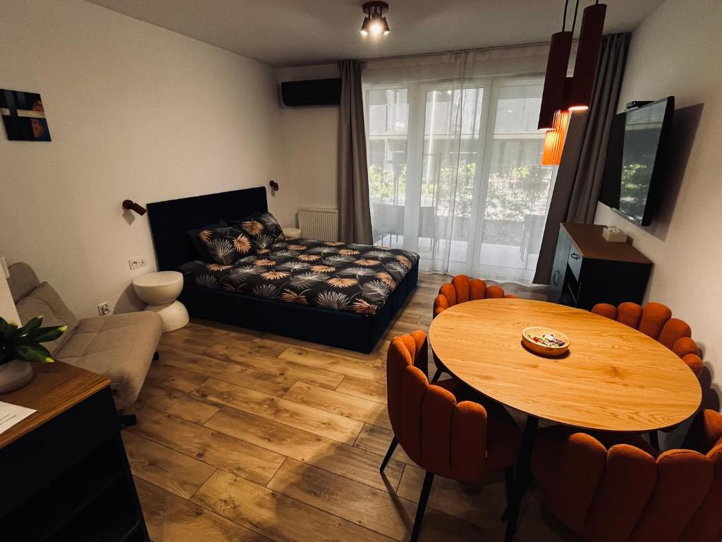 a living room with a table and a couch at Marina Portovo in Gdańsk