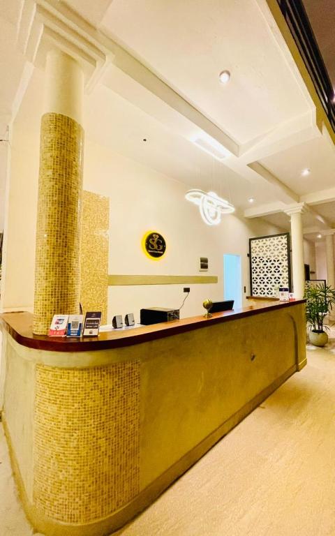 a lobby with a reception desk with a pillar at Secret Gem in Arugam Bay