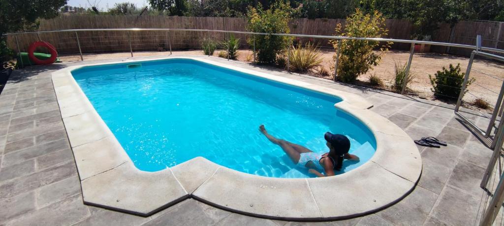 a woman swimming in a swimming pool at Casa Tere in Codo
