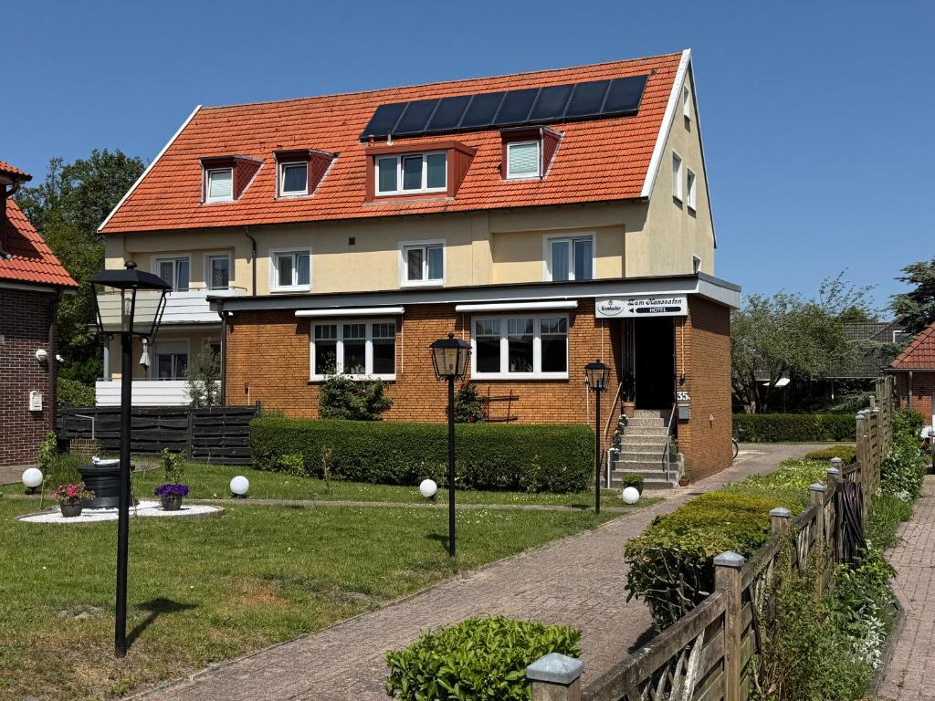 a house with solar panels on the roof at Hotel Zum Hanseaten in Borkum