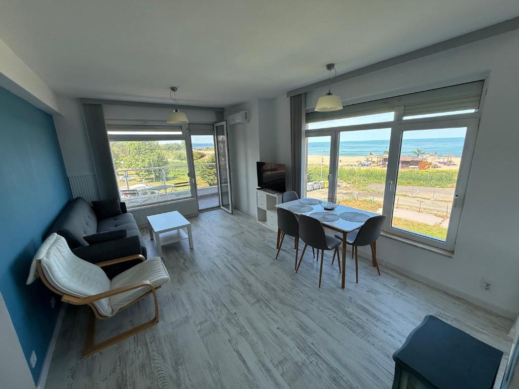 a living room with a couch and a table and chairs at Апартамент Солана - Apartment Solana in Lozenets