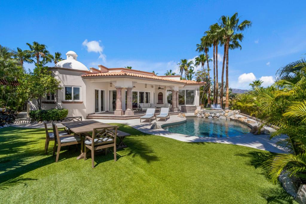 a house with a table and chairs and a swimming pool at Palmilla Golf and Beach Villa in San José del Cabo
