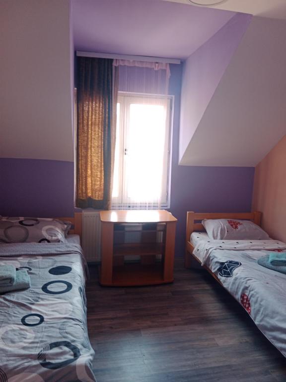 a small room with two beds and a window at Juzna Prica in Ćuprija