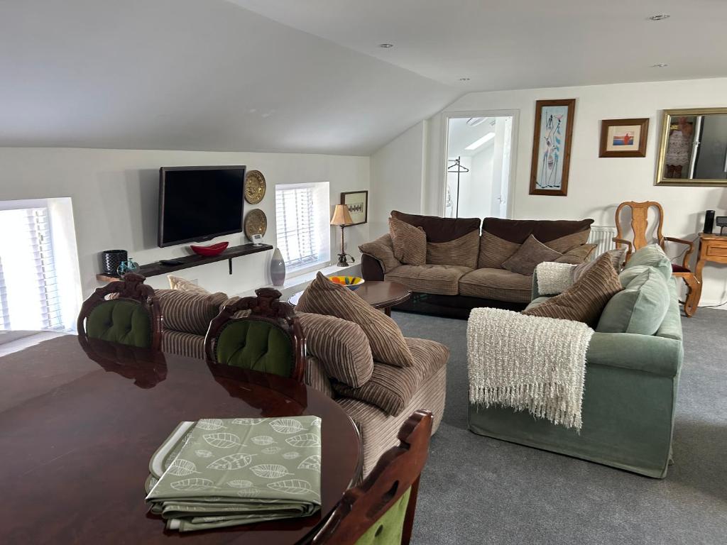 a living room with a couch and a table at New Drovers in Llanelli