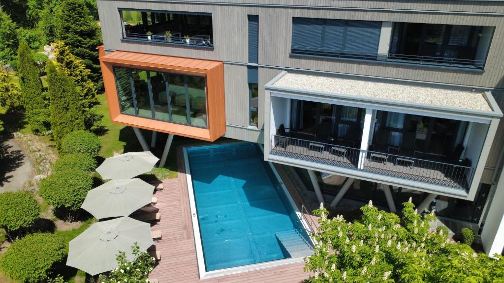 an aerial view of a building with a swimming pool at Parkhotel Flora am Schluchsee in Schluchsee
